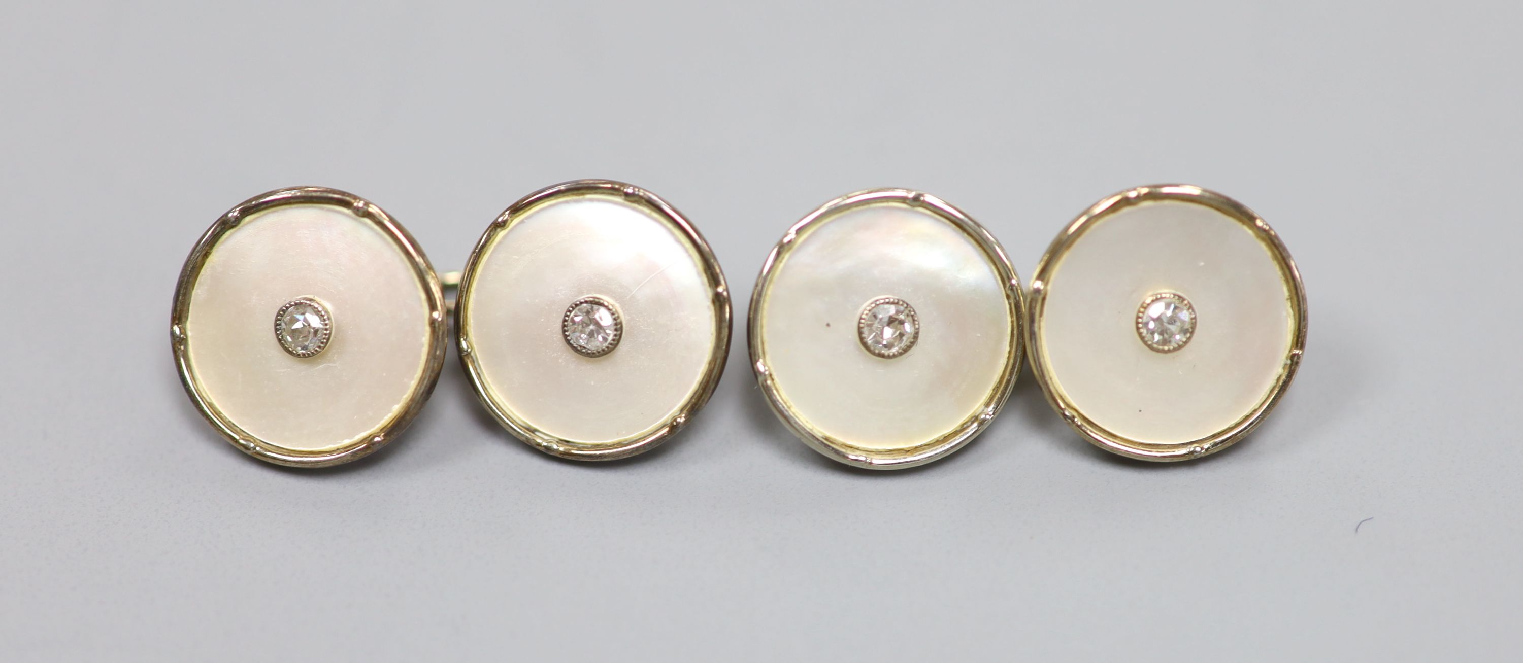 A pair of 18ct, mother of pearl and diamond set circular cufflinks